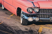 A shot of the front right view of a classic 1959 pink Cadillac behind the skid marks.. Original public domain image from Wikimedia Commons