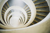 A white, grey, and yellow spiral staircase. Original public domain image from <a href="https://commons.wikimedia.org/wiki/File:Spiral_staircase_(Unsplash).jpg" target="_blank" rel="noopener noreferrer nofollow">Wikimedia Commons</a>