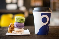 Colorful macarons stacked next to a cup of coffee. Original public domain image from Wikimedia Commons