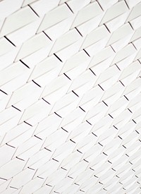A pattern of white geometric shapes in a facade. Original public domain image from Wikimedia Commons