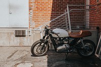 Motorcycle parked in the shade near the railing of a building. Original public domain image from <a href="https://commons.wikimedia.org/wiki/File:DREAM_BIKE_(Unsplash).jpg" target="_blank" rel="noopener noreferrer nofollow">Wikimedia Commons</a>