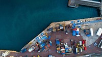 An overhead shot of Saint Peter Port with shipping containers next to the calm sea.. Original public domain image from Wikimedia Commons