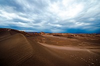 Clouds on a bright day over the sand dunes in Atacama Desert. Original public domain image from <a href="https://commons.wikimedia.org/wiki/File:Clouds_Over_The_Desert_(Unsplash_AKuzZrpJJew).jpg" target="_blank" rel="noopener noreferrer nofollow">Wikimedia Commons</a>