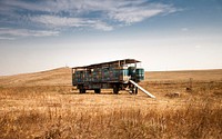 A truck holding different colored crates in a grassy field on a farm. Original public domain image from <a href="https://commons.wikimedia.org/wiki/File:Truck_and_supplies_(Unsplash).jpg" target="_blank" rel="noopener noreferrer nofollow">Wikimedia Commons</a>