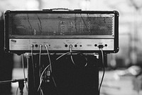 Black and white close up of shot of amplifier with cables and cords. Original public domain image from <a href="https://commons.wikimedia.org/wiki/File:Monochrome_amp_(Unsplash).jpg" target="_blank" rel="noopener noreferrer nofollow">Wikimedia Commons</a>