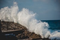 Big wave splashes on the coastline rocks. Original public domain image from Wikimedia Commons