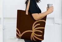 Woman with a brown tote bag side view