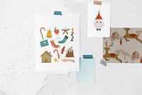 Christmas card papers on white wall, holiday stickers