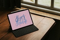 Happy Holidays greeting on tablet screen