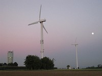 Wind turbines at dawn. Original public domain image from <a href="https://commons.wikimedia.org/wiki/File:Wind_turbines,_water_tower,_Oberjettingen.jpg" target="_blank">Wikimedia Commons</a>