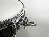Snare drum strainer, used to enable or disable snares on a snare drum. Original public domain image from Wikimedia Commons