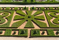Part of the formal gardens of Château de Hautefort, Dordogne, France. Original public domain image from <a href="https://commons.wikimedia.org/wiki/File:Ch%C3%A2teau_de_Hautefort_Jardins_3.jpg" target="_blank" rel="noopener noreferrer nofollow">Wikimedia Commons</a>