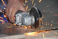 Cutting iron with a metal cutting machine. Original public domain image from Wikimedia Commons