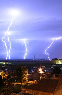 Lightning over the outskirts of Oradea, Romania, during the August 17, 2005 thunderstorm which went on to cause major flash floods over southern Romania. Original public domain image from Wikimedia Commons
