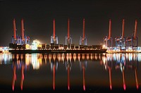 Container ship Colombo Express at the Altenwerder container terminal in Hamburg, Germany. The port cranes are reflecting in the water. Original public domain image from <a href="https://commons.wikimedia.org/wiki/File:Colombo_Express_in_Altenwerder_at_night-799096.jpeg" target="_blank" rel="noopener noreferrer nofollow">Wikimedia Commons</a>