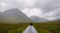 Adventure desktop wallpaper background, SUV on a road through the Scottish Highlands, Scotland