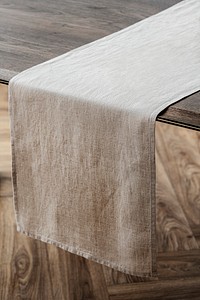 Plain beige table runner on a wooden table