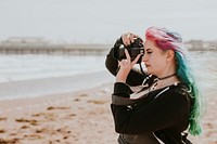 Artsy woman taking a photo at a beach