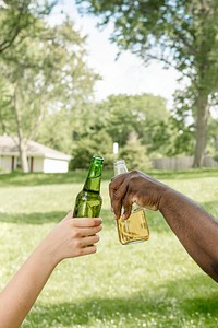 Cheers with beer at a summer party in the park