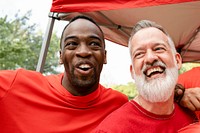 Cheerful men hugging at a tailgate party