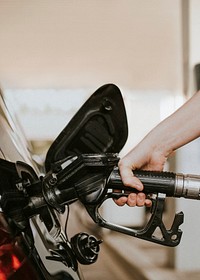 Woman filling petrol at a gas station