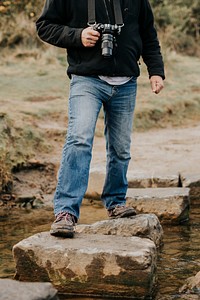 Man sightseeing the nature and crossing the stream