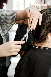 Customer getting a haircut in a beauty salon