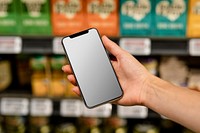 Blank phone screen image, held by a woman doing grocery shopping