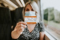 Woman showing a daily pass train ticket 