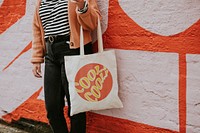 Woman carrying reusable canvas tote bag 