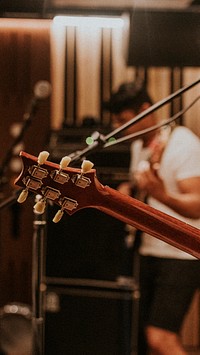 Music band guitarist performing in recording studio