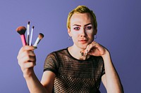 Non-binary beauty blogger with makeup tools