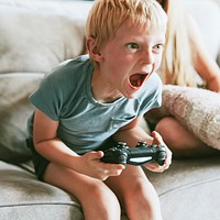 Boy playing video game in living room