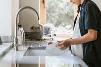 Boy washing dishes, basic house chores