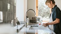 Boy washing dishes, basic house chores