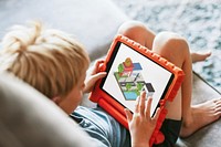 Young boy playing game on tablet