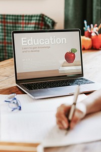 Blond girl using laptop for online class, the new normal