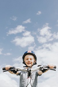 Kid’s hobby background, boy riding a bike, summer hobby