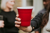 Happy friends toasting to celebrate at a Christmas party