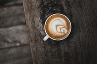 Free cappuccino on wooden table top view photo, public domain beverage CC0 image.