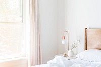 A copper lamp sits on a bedside table by a window in a brightly lit room, free public domain CC0 image.