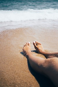 Free wave touching woman feet public domain CC0 photo.