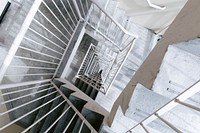 A persepctive photo looking down a winding square stairwell, free public domain CC0 image.