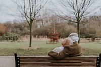 Lovely old couple on park bench background