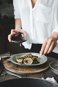 Free woman seasoning her meal with hot spice image, public domain food CC0 photo.