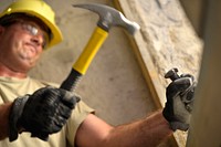 U.S. Air Force Senior Master Sgt. Kurt Huver, with the 133rd Civil Engineering Squadron (CES), Minnesota Air National Guard (MNANG), chisels out old tile in a restroom at an elementary school in Ogulin, Croatia, June 27, 2014.