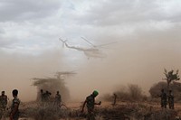 A UN helicopter carrying Prime Minister Abdiweli and his delegation depart from Tiyeglow following a visit to the recently liberated town on 4th September 2014. AMISOM Photo / Ilyas A. Abukar. Original public domain image from Flickr