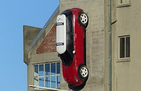 Red car was hanging agiant the wall. FZ200. Parking is not too tight in Christchurch for this Mini Cooper. Original public domain image from Flickr