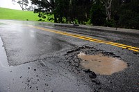 Asphalt broken road caused by the heavy rain. Original public domain image from Flickr