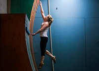 Kim Wienches reaches for the top of the Curved Wall at Pinnacle Parkour Academy on Aug. 26. Original public domain image from Flickr